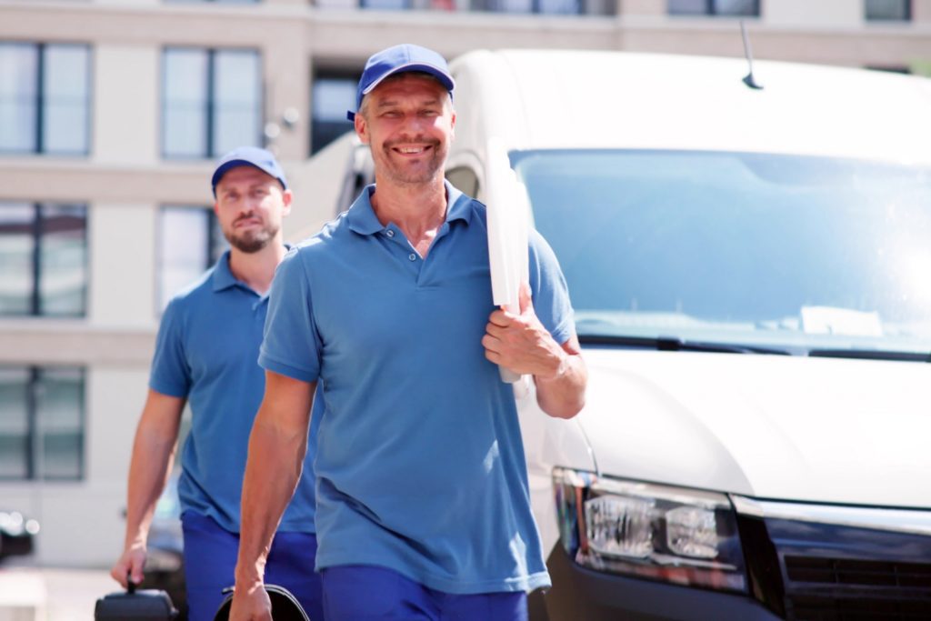 Technician Electrician Man With Cable Near Van