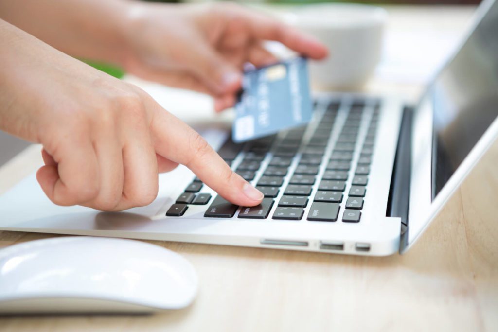 hand-with-credit-card-laptop