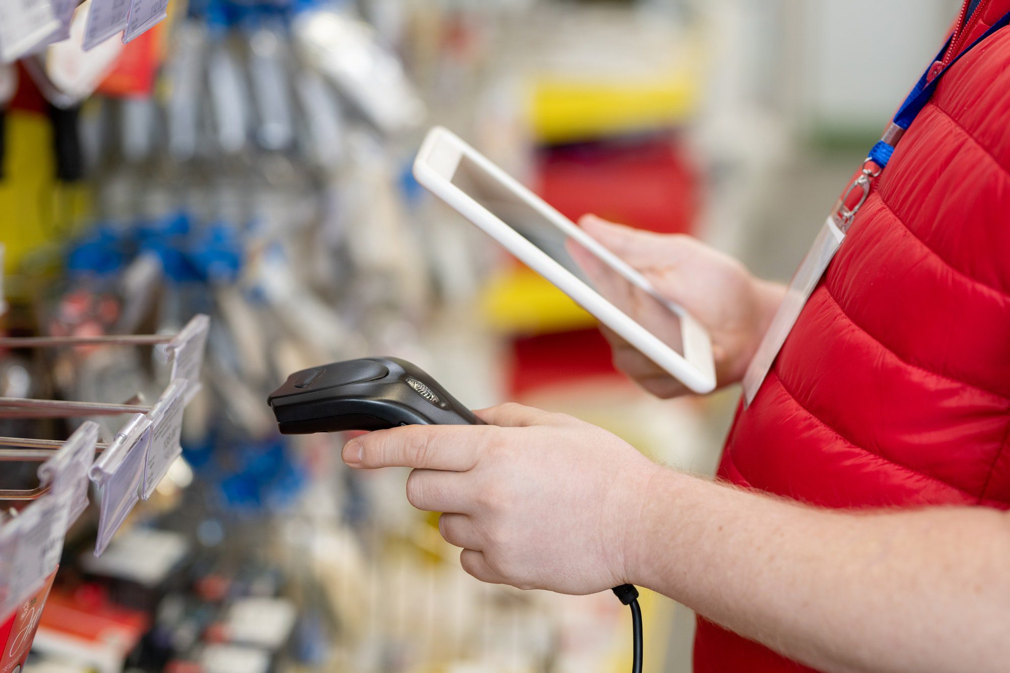 Sales manager scanning price tags in hardware store