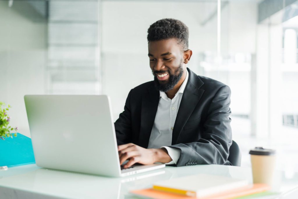 thoughtful-african-american-businessman-using-laptop-pondering-project-business-strategy-puzzled-employee-executive-looking-laptop-screen-reading-email-making-decision-office